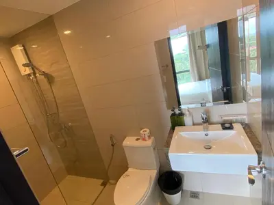 a bathroom with a shower and a toilet and a sink at 1BR 2 mins to Okada near MOA & Airport-12C in Manila