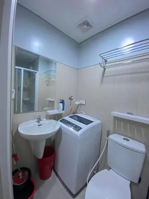 a bathroom with a white toilet and a sink at Great Price and Location in Moa, Pasay City, Philippines in Manila