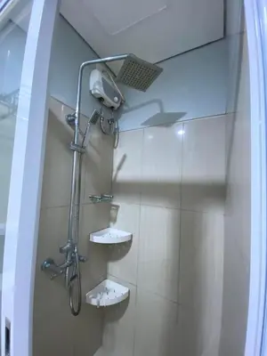 a shower in a bathroom with two sinks at Great Price and Location in Moa, Pasay City, Philippines in Manila