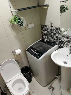 a small bathroom with a toilet and a sink at Affordable unit near MOA walking distance to picc in Manila