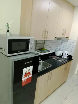 a kitchen with a microwave and a sink at Affordable unit near MOA walking distance to picc in Manila