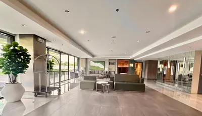 a lobby with a couch and chairs and a table at ARCHIVED 2019 - Cavite Condo with Resort-like Amenities & Hi Speed Wifi in Dasmariñas