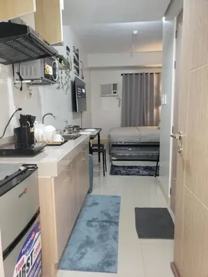 a kitchen with a sink and a bed in a room at ARCHIVED 2019 - Cavite Condo with Resort-like Amenities & Hi Speed Wifi in Dasmariñas
