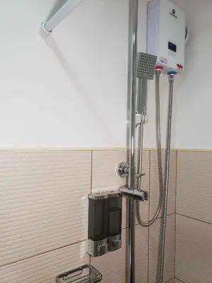 a shower in a bathroom with aperature at ARCHIVED 2019 - Cavite Condo with Resort-like Amenities & Hi Speed Wifi in Dasmariñas