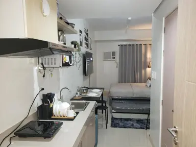 a small kitchen with a sink and a bed at ARCHIVED 2019 - Cavite Condo with Resort-like Amenities & Hi Speed Wifi in Dasmariñas