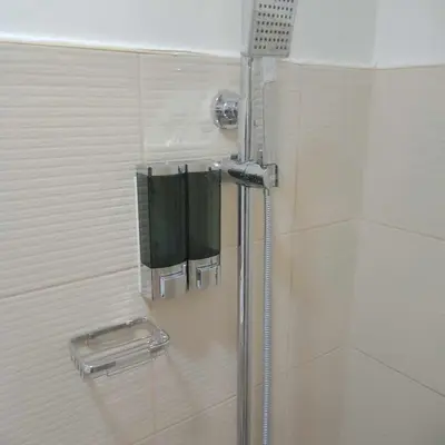 a shower in a bathroom with a glass door at ARCHIVED 2019 - Cavite Condo with Resort-like Amenities & Hi Speed Wifi in Dasmariñas