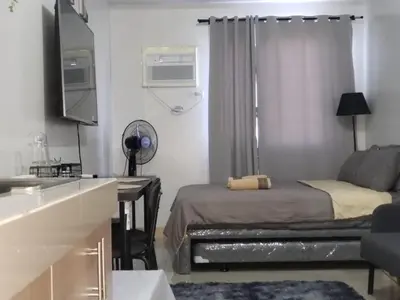 a small room with a bed and a desk at 2019 Cavite Green 2 Condo Amenities HI Speed Wifi in Dasmariñas