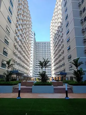 two tall buildings with palm trees in a park at 2019 Cavite Green 2 Condo Amenities HI Speed Wifi in Dasmariñas
