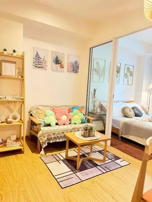 a living room with a couch and a bed at Maldives Tower Azure in Manila