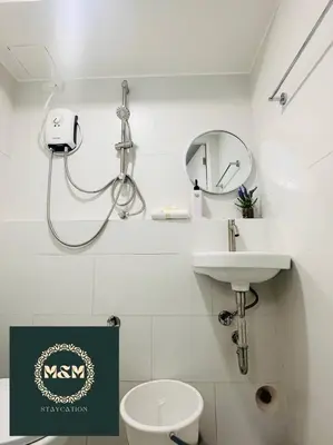 a bathroom with a shower and a toilet and a sink at 2 Bedroom and Bathroom Staycation Condo in Mandaluyong City near BONI MRT with WIFI and KARAOKE and POOL in Manila