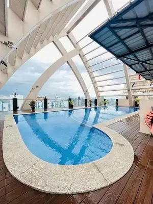 a large swimming pool on the roof of a building at 2 Bedroom and Bathroom Staycation Condo in Mandaluyong City near BONI MRT with WIFI and KARAOKE and POOL in Manila