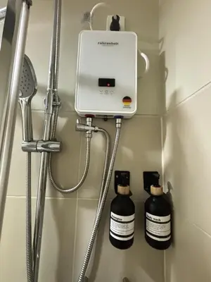 a bathroom with a soap dispenser and two bottles at Cozy and Stylish Unit in Fame Residences in Manila