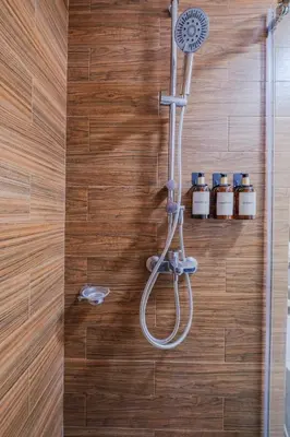 a bathroom with a shower with a shower head at 1Br Suite w Balcony in Pasay - The Radiance Manila Bay in Manila