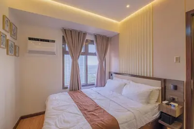 a bedroom with a large bed with a window at 1Br Suite w Balcony in Pasay - The Radiance Manila Bay in Manila