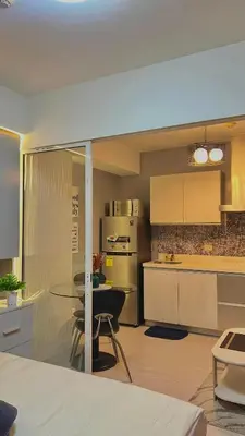 a kitchen with a glass table in a kitchen at Yana's Place - Azure Residences in Manila