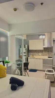 a kitchen with a table and a dining room at Yana's Place - Azure Residences in Manila