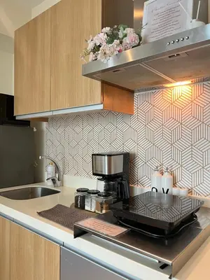 a kitchen with a coffee maker on a counter at Cozy Stays - Azure in Manila