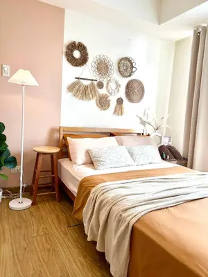 a bedroom with a bed with decorations on the wall at Cozy Stays - Azure in Manila