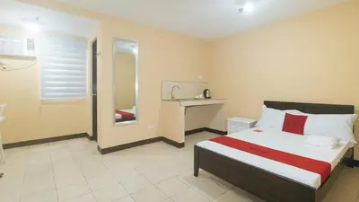 a bedroom with a bed and a sink in it at RedDoorz at MUBG Apartelle near Baclaran Church in Manila