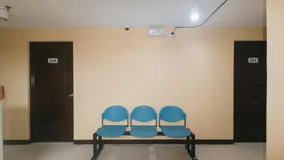 three blue chairs sitting in a waiting room at RedDoorz at MUBG Apartelle near Baclaran Church in Manila