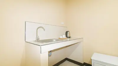 a bathroom with a sink and a toilet at RedDoorz at MUBG Apartelle near Baclaran Church in Manila