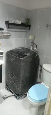 a bathroom with a toilet and a tv in it at CHIC ROOM pasay sea residence in Manila