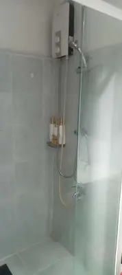 a bathroom with a shower with a glass door at CHIC ROOM pasay sea residence in Manila