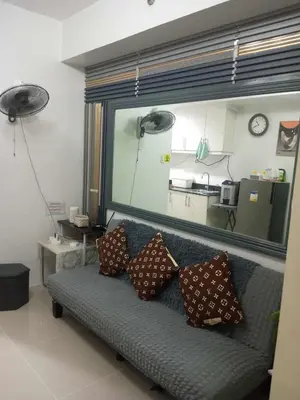 a couch with pillows on it in a living room at CHIC ROOM pasay sea residence in Manila