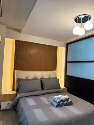 a bedroom with a bed with two towels on it at Sleek & Chic One-Bedroom in Manila