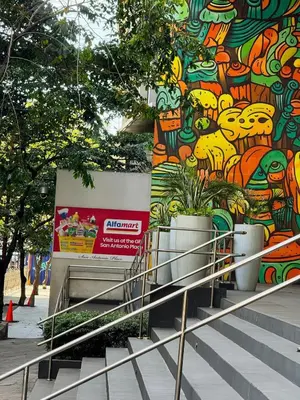 a building with a mural on the side of it at Sleek & Chic One-Bedroom in Manila