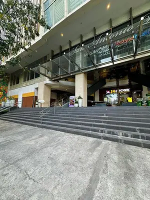 a large building with stairs in front of it at Sleek & Chic One-Bedroom in Manila