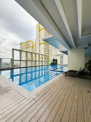 a swimming pool on the roof of a building at Sleek & Chic One-Bedroom in Manila