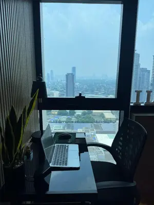 a laptop computer sitting on a table in front of a window at Modern Nordic Noir Suite Cozy Luxury Scenic View in Manila