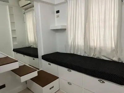 a kitchen with white cabinets and a black counter top at Modern Japanese Resort-Type Condo in Manila