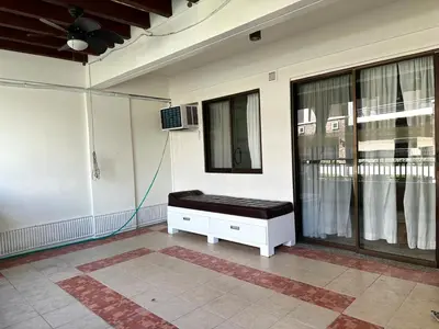 a room with a bench on the side of a house at Modern Japanese Resort-Type Condo in Manila