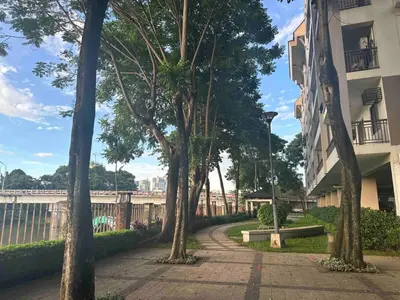 a sidewalk with trees next to a building at Modern Japanese Resort-Type Condo in Manila