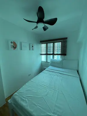 a bedroom with a bed with a ceiling fan at EDSA Cozy 3BR near MRT w Netflix and Karaoke Fun in Manila