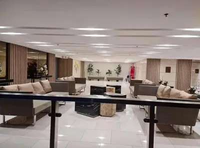 a large living room with couches and tables at Field Residences Hotel Apartments Near Manila Airport in Manila
