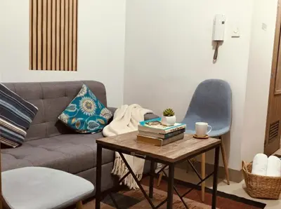 a living room with a couch and a table at Mall of Asia Accommodation in Manila