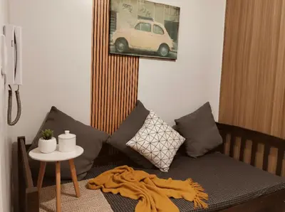 a living room with a couch and a table at Mall of Asia Accommodation in Manila