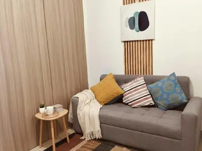 a living room with a couch and a table at Mall of Asia Accommodation in Manila