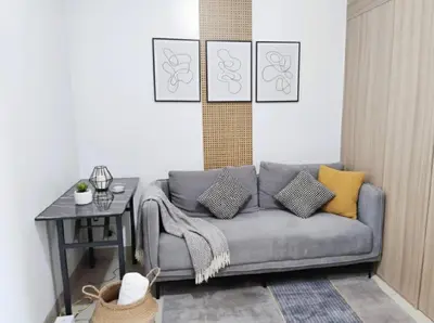 a living room with a couch and a table at MOA Apartment in Pasay in Manila