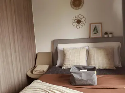 a bedroom with a bed with a bag on it at MOA Apartment in Pasay in Manila