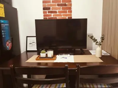 a desk with a computer monitor on top of it at MOA Apartment in Pasay in Manila