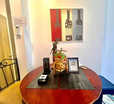 a wooden table with a vase on top of it at Central Ortigas Condo in Manila