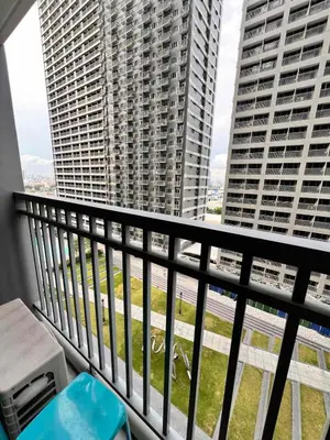 a balcony with a view of two tall buildings at Central Ortigas Condo in Manila