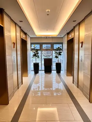 a hallway with two potted trees in a building at SMDC FAME Apartment in Manila