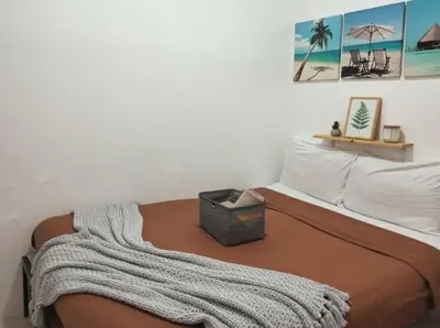 a bedroom with a bed with a blanket on it at SMDC FAME Apartment in Manila