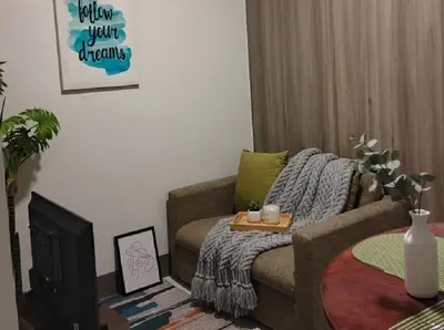 a living room with a couch and a coffee table at SMDC Ortigas FAME in Manila