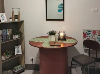 a small table with a candle on it in a room at SMDC FAME in Ortigas in Manila